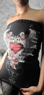 Black strapless top with floral lace details on a plain background