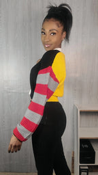 Woman wearing a colorful sweater with a neutral background