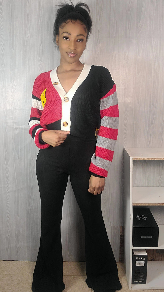 Person wearing a colorful cardigan with a plain background Hover Image